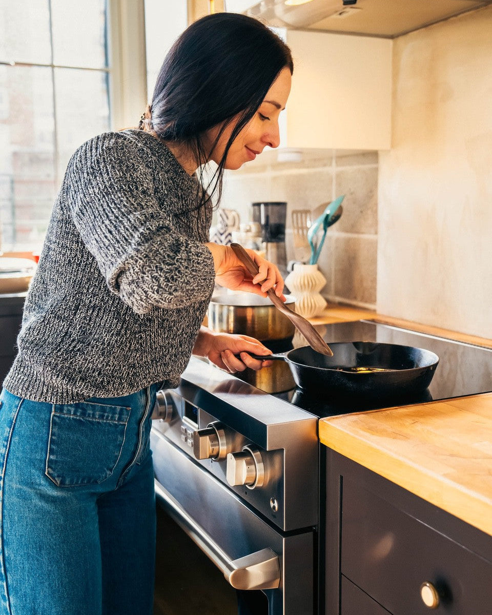 Woman cooking with Electra Induction Stove